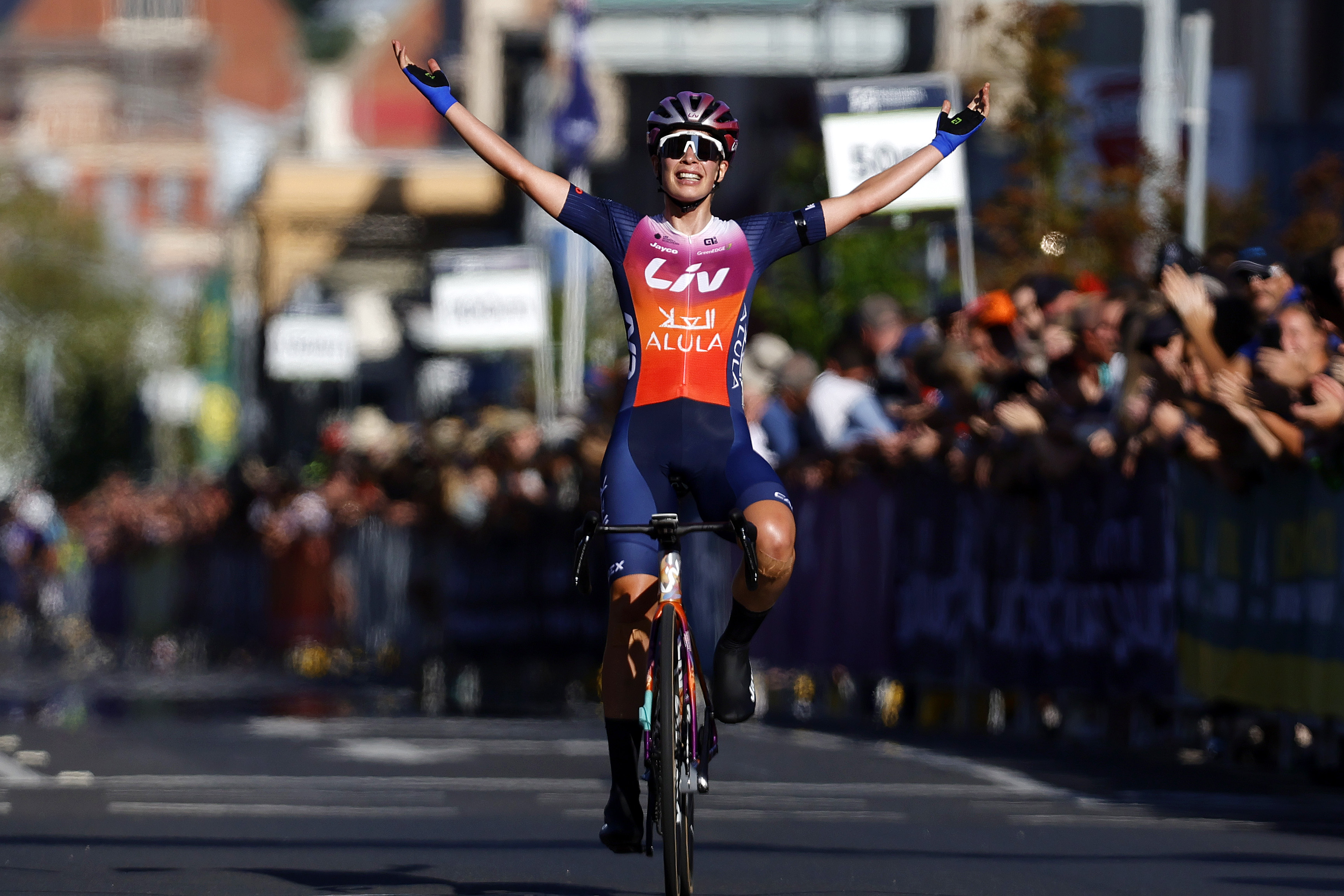 Ruby Roseman-Gannon salutes the crowd as she wins the 2024 criterium national championship in Ballarat